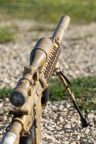 Airsoft sniper rifle in desert camouflage