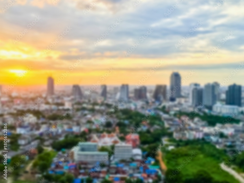 Fototapeta premium City skyline at sunset with golden sun and clouds