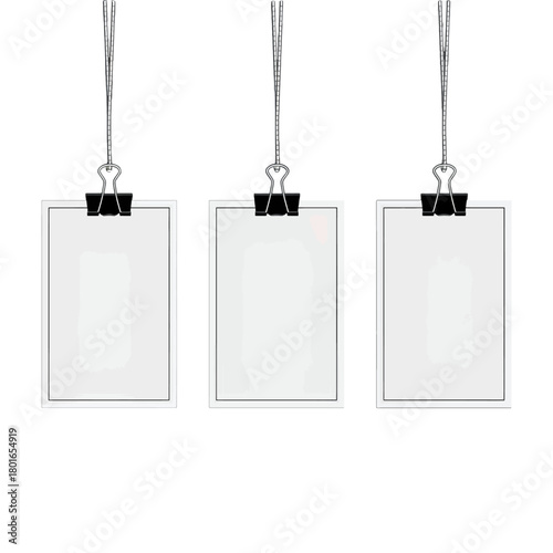 Three blank clipboards suspended by strings