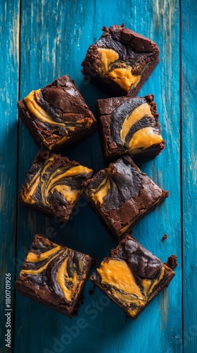 Delicious Swirled Brownies With Vibrant Orange Topping on Blue Wooden Surface