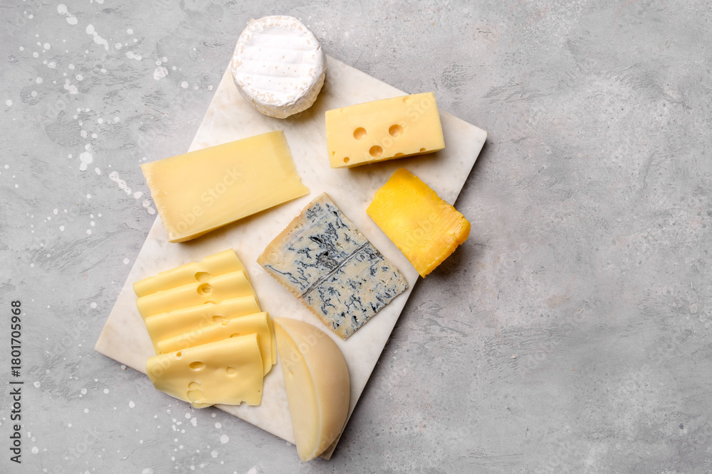 Fototapeta premium Italian and French gourmet cheese platter with craft cheese assortment on a marble platter. hard cheeses, mold cheese, gorgonzola, pecorino, Emmental, Roquefort cheddar