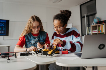 High school students working on robotics project. Girls in STEM.