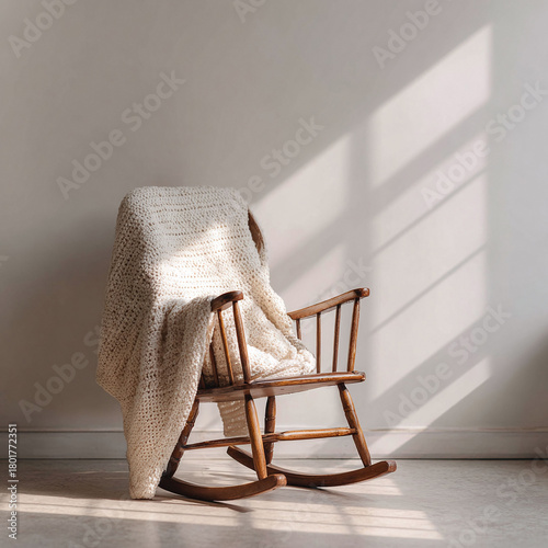 Wooden rocking chair with a cozy knit blanket, bathed in sunlight. Evokes warmth, relaxation, and nostalgia. Ideal for home decor, lifestyle, or comfortthemed projects.