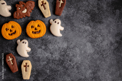 Halloween-themed cookies on dark textured background
