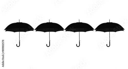 Four black umbrellas in a row for weather
