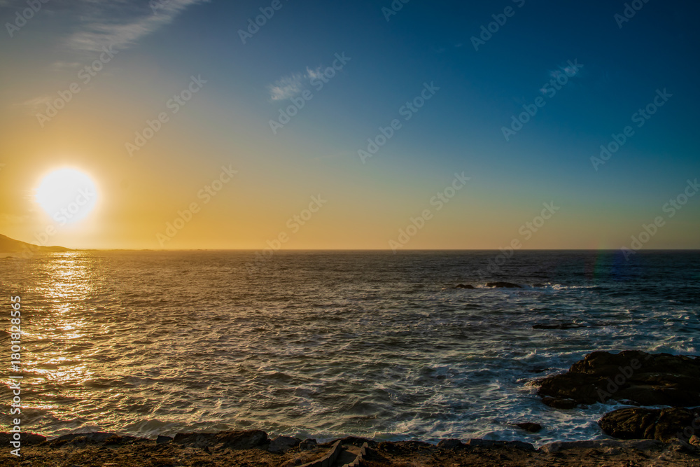 Fototapeta premium Golden Sunset Over Rocky Coastline