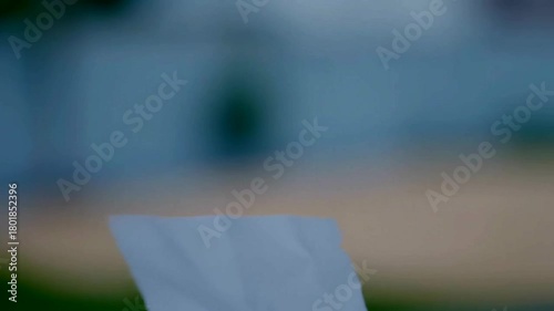 Weightless Paper Dance: A Delicate Ballet of Floating Sheets in an Abstract Ambiance