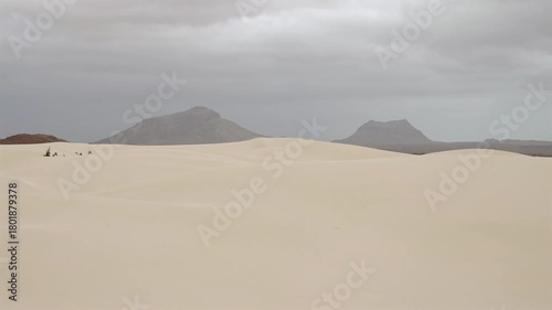 Sand dunes in Viana desert close up at overcast day, background volcanic mountains, Boa vista , Cape Verde.