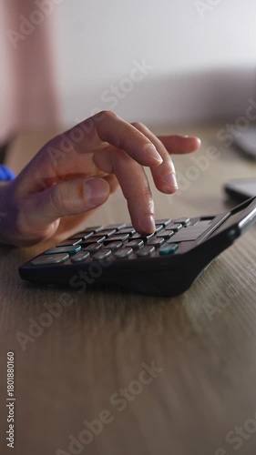 An accountant uses a calculator to calculate profit and income.
A person at a desk calculating finances using a calculator.
Using a calculator.
Math, calculator, profit, income, money, economics
