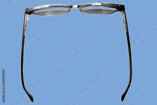 close up of eyeglass frame pixelate grayscale color halftone dotted texture style collage element isolated on blue background. top view. flatlay.