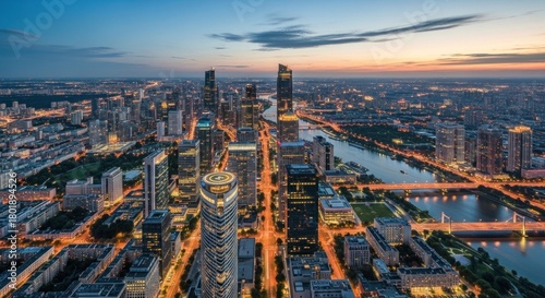 A bustling city skyline at dusk, with tall buildings illuminated by the glow of city lights.