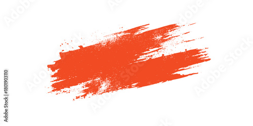 Bright orange textured paint brush stroke with splatters on a white background abstract graphic element