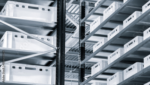 Modern distribution center warehouse with high-rise shelving and plastic containers. Logistics, storage, and delivery concept.