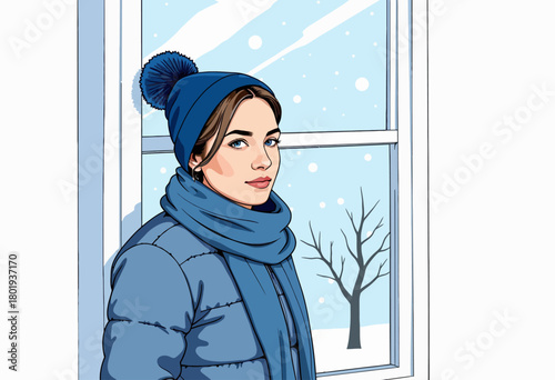 Young woman in a warm blue coat and hat stands by a window, gazing outside at a serene winter landscape with falling snow and a leafless tree in the background