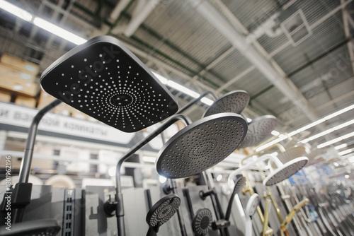 New plumbing shower faucets in a hardware store. Stainless steel faucet.