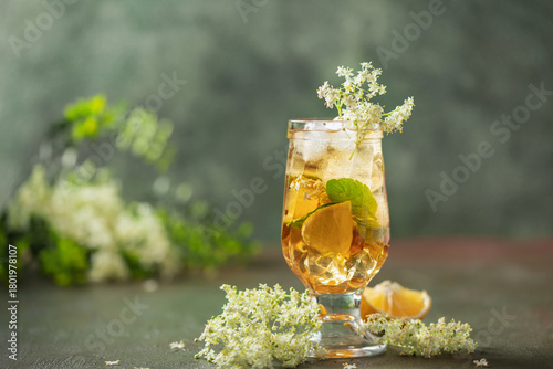 Hugo spritz cocktail  with wine, elderflower syrup, lemon, mint and ice in glass on the table