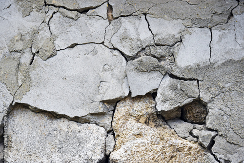 Old cracked and partially collapsed plaster. Copy space. Close-up. Selective focus.