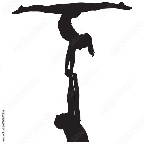 Silhouetted acrobats perform a dynamic and balanced human pyramid pose