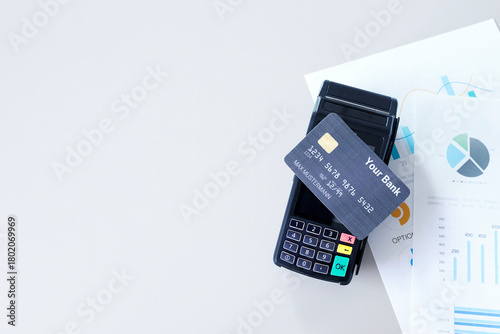 Contactless payment. Credit card on payment terminal over office desk.  Money transfer concept