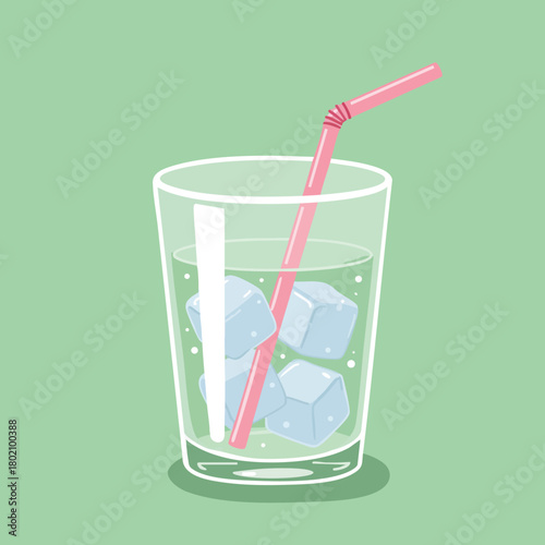 Refreshing glass of iced drink with ice cubes and a straw on a green background for summer enjoyment 