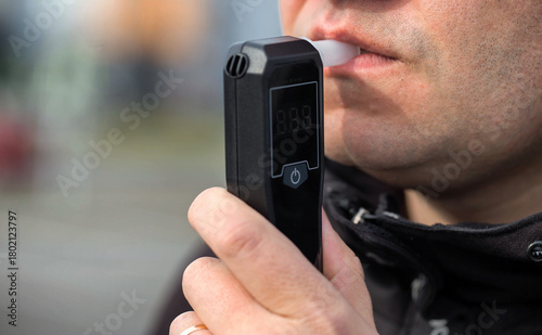 Картината върху платно Male Driver Using Personal Alcometer For Sobriety Check