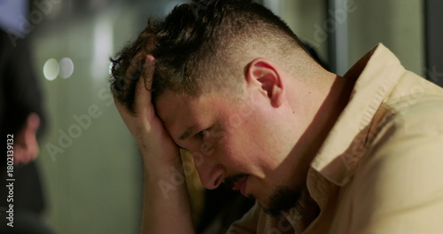 Angry manager shouting during tense business meeting in modern office with analytics presentation in background, scolding employee, workplace conflict and leadership stress