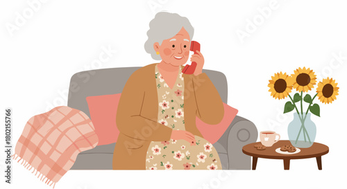 Happy senior woman talking on a retro landline phone, sitting comfortably on a sofa at home with sunflowers, tea, and cookies nearby, enjoying a cozy moment.
