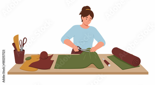 Smiling woman cutting green fabric on a wooden crafting table, surrounded by various sewing tools and materials for a DIY or textile project.