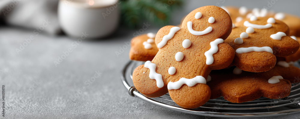Fototapeta premium Gingerbread cookies with icing on cooling rack, perfect for Christmas and New Year celebrations, evoke warmth and joy