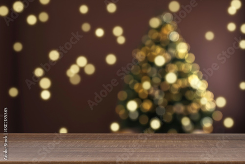 Empty wooden table against blurred Christmas tree, bokeh lights. Space for design