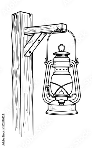 vintage kerosene lamp hanging on wood post