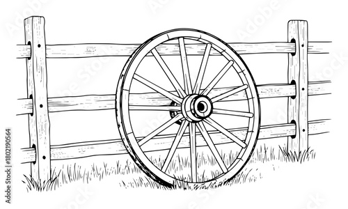 old wagon wheel leaning on a wooden fence