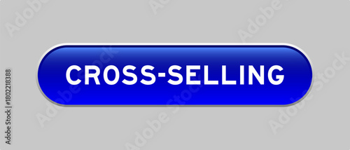 Blue color capsule shape button with word cross selling on gray background