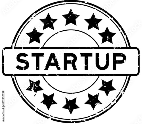 Grunge black startup word with star icon round rubber seal stamp on white background
