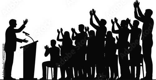 Silhouette of audience applauding speaker at podium