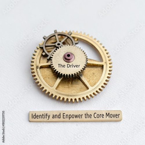 Intricate miniature bronze clockwork mechanism with engraved message on a white background