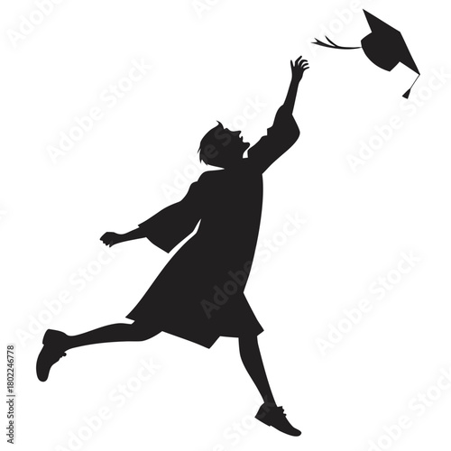 A graduate in gown throwing graduation cap in the air isolated on the silhouette of a student celebrating graduation day with excitement and joy