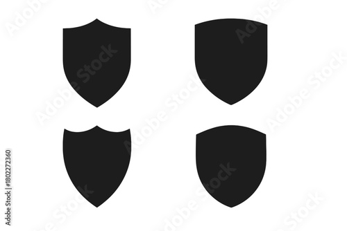 Four black heraldic shield shapes isolated on white background