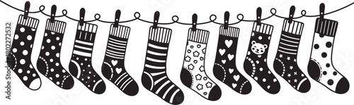 Festive Christmas stockings hanging on a rope in black and white