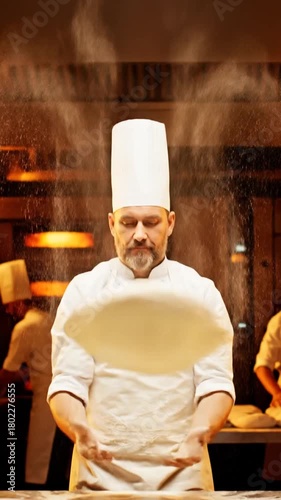 Chef tossing dough in a commercial kitchen preparing food for restaurants or culinary projects