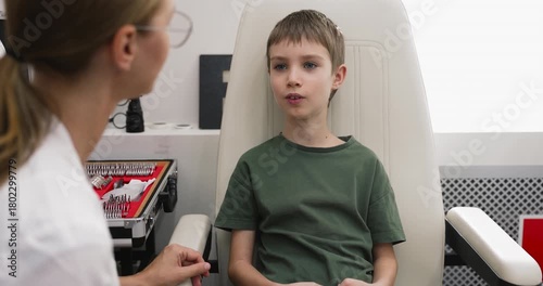 Child talking with optometrist during eye check-up