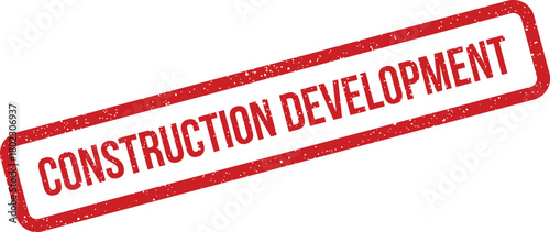 A bright red grunge rubber stamp impression stating Construction Development appears diagonally on a simple white surface