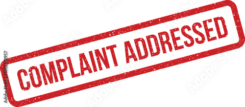 A distressed red rectangular rubber stamp prominently shows the clear text COMPLAINT ADDRESSED on a pure white surface