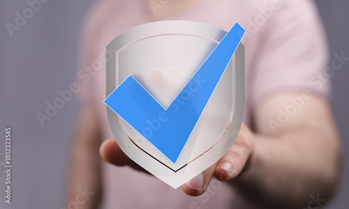 Hand holding a shield icon ...