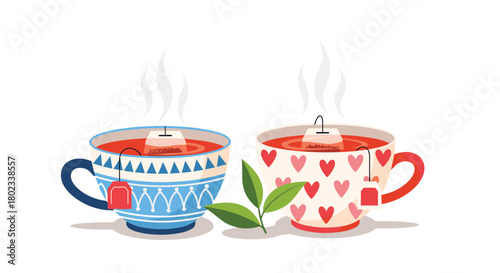 Two steaming cups of tea with tea bags and a sprig of green leaves.