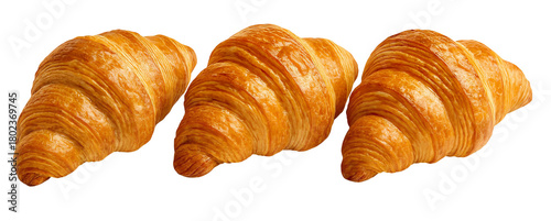Horizontal row of three golden flaky French croissants