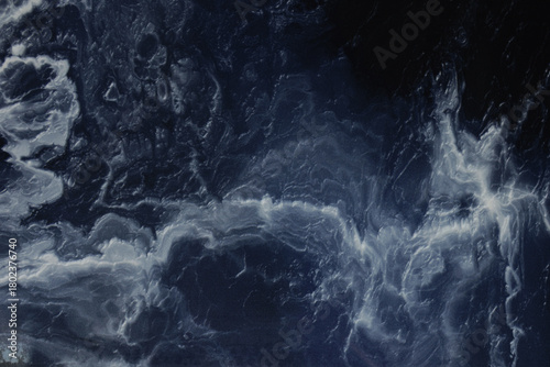 Marble is blue. Light streaks on a marble background. The background is made of blue marble. Granite marble.