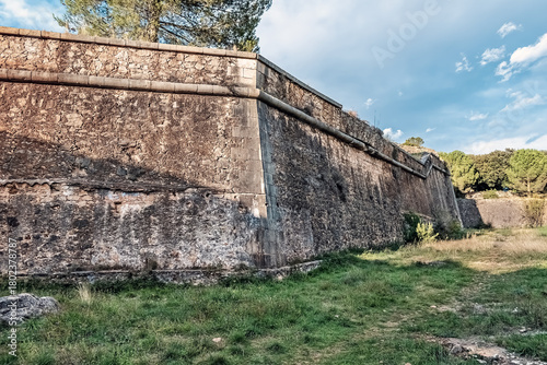 Obraz na plátně Ancient stone walls of Montjuic Castle in Girona, Spain, with weathered masonry,