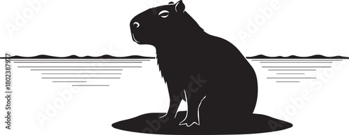 Silhouetted capybara sitting peaceful near water wildlife nature scene majestic rodent