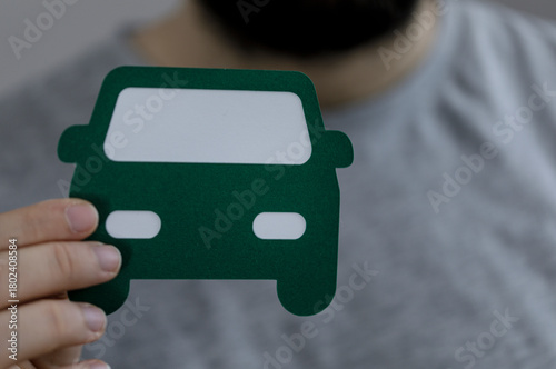 Person's hand holding a gre...